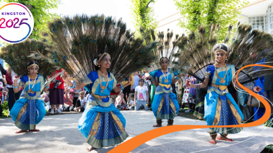 Girls dancing in peacock-style dresses with feathers