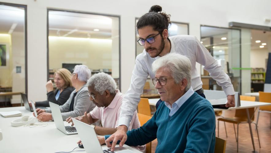 Older learners in a classroom with a teacher