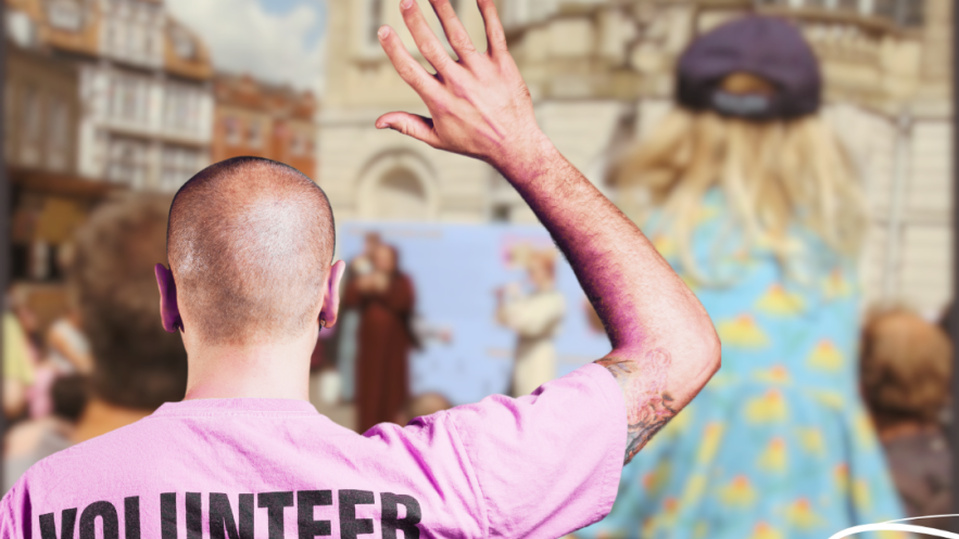 volunteer rises hand